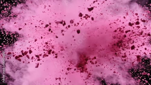 Two makeup brushes collide, creating a swirl of pink powder particles on a black background. 4k video