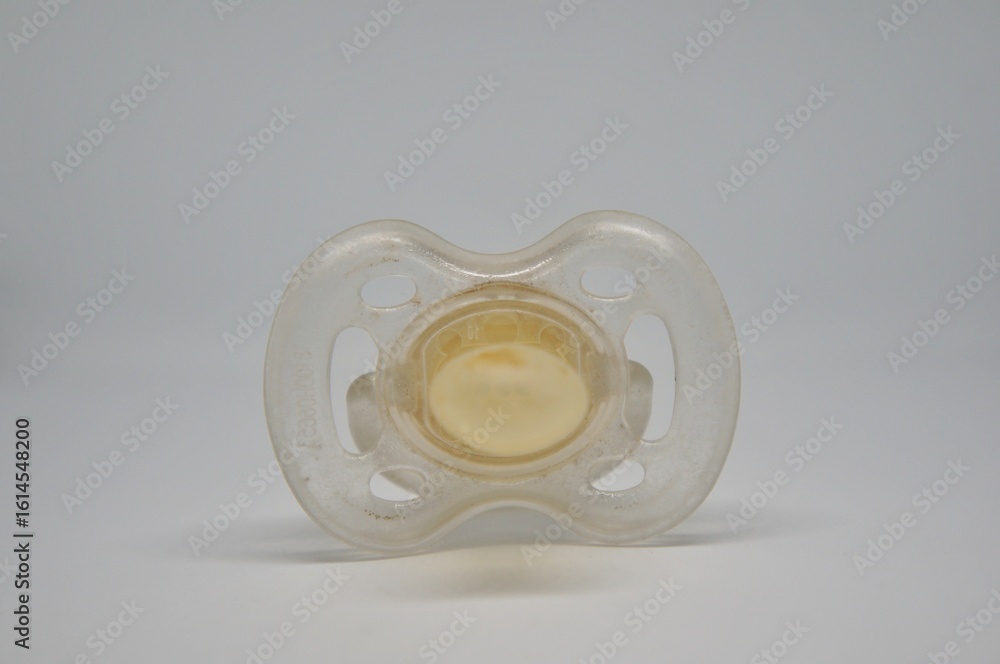 Fototapeta premium Broken baby pacifier with rubber nipple on white background