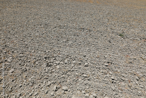 background of very arid summer terrain of the cultivated field with dry earth due to drought in the vast plain
