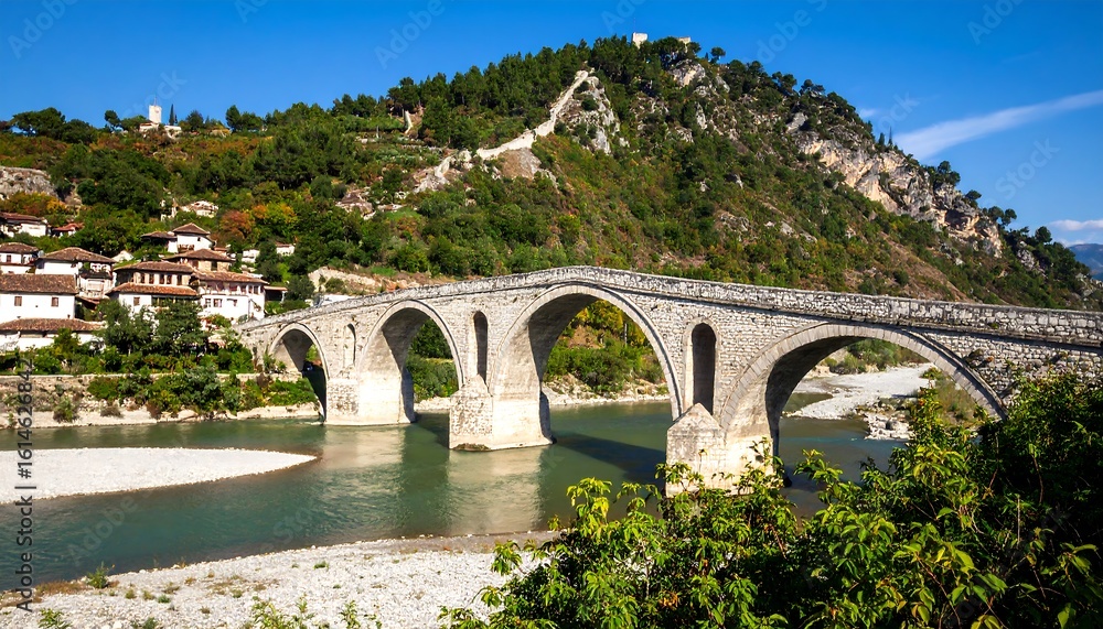 Fototapeta premium Stone bridge over a river in a valley