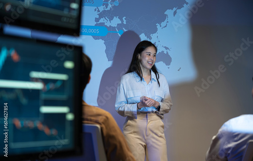 Businesswoman presents a marketing strategy using a ship route map, promoting global product distribution and sales logistics in a corporate setting during a professional presentation.