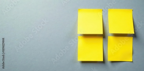 Close-up of four yellow sticky notes on a textured gray surface Clean, simple aesthetic , organization, note taking