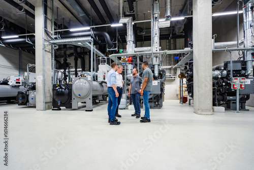 Wallpaper Mural Businessmen and employees having a meeting in factory Torontodigital.ca