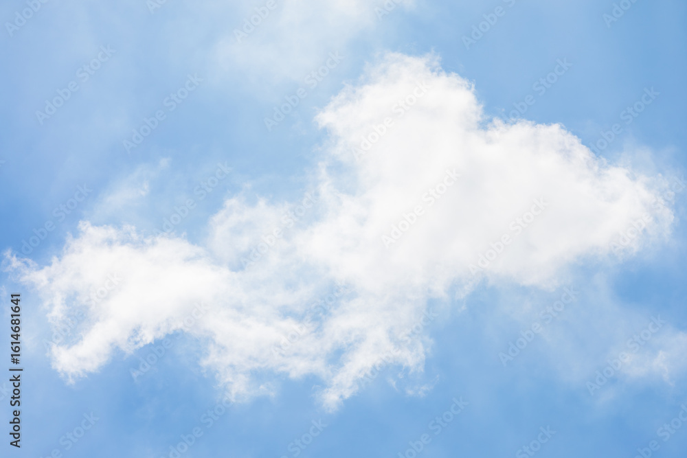 Fototapeta premium Fluffy White Clouds in a Bright Blue Sky.