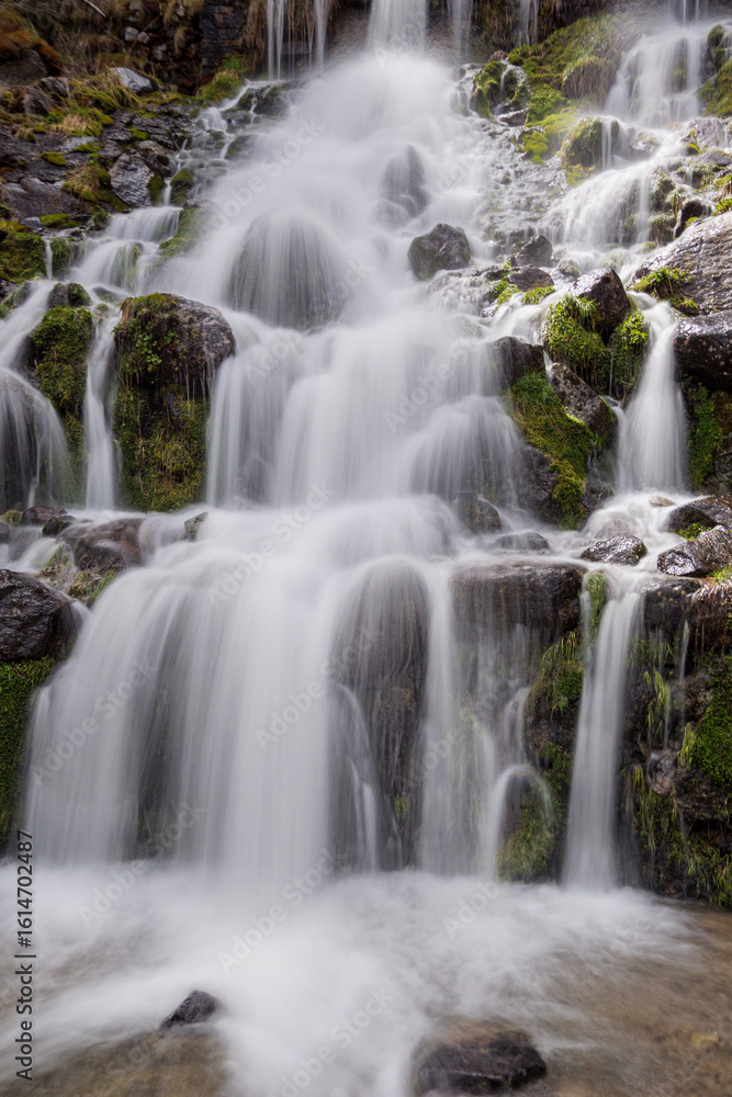 Waterfall Cascading Over Mossy Rocks with Smooth Water Effect Waterfall Cascading Over Mossy Rocks with Smooth Water Effect