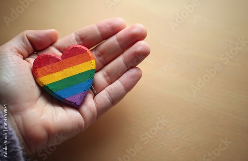 Wallpaper Mural Hand holds vibrant rainbow heart symbol. Represents LGBT pride, equality, and tolerance. Celebrates International Day Against Homophobia, bisexual, gay, lesbian, transgender rights. Torontodigital.ca