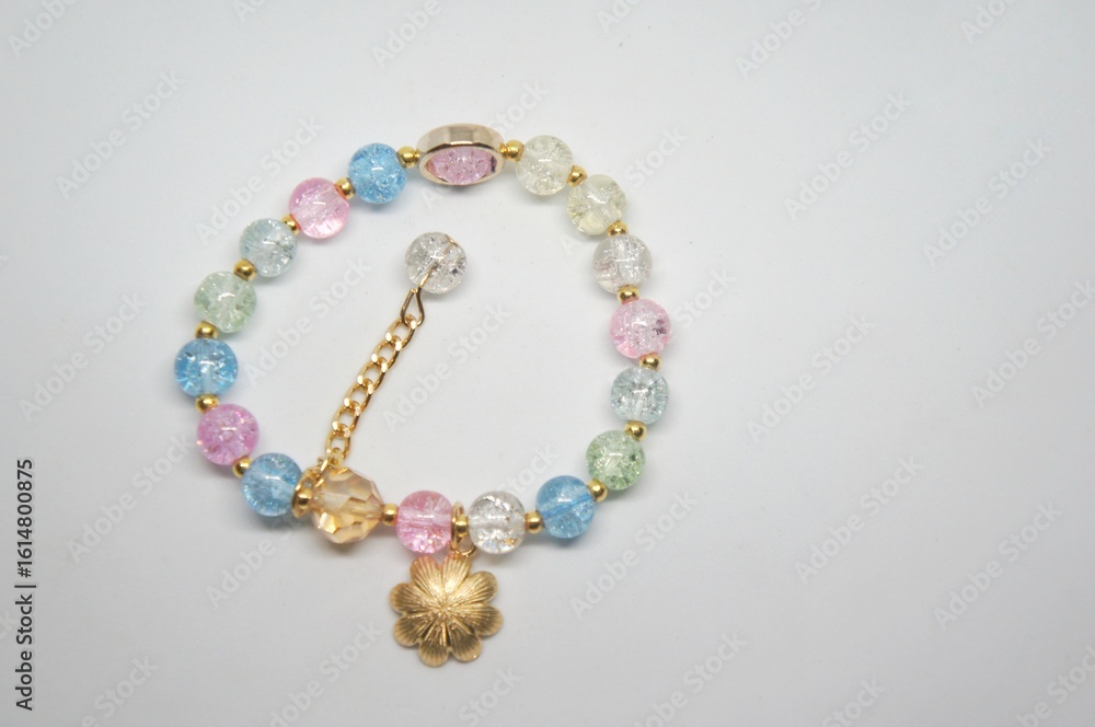 Fototapeta premium Handmade children's beaded jewelry. Necklaces and bracelets made of colorful beads and pearls. DIY beaded bracelets. Children's crafts. Creativity and hobbies. Art activities for children.