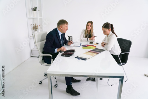 Business meeting in a modern office with team discussing project designs