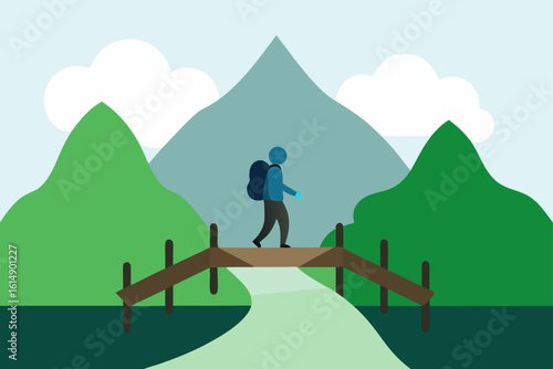 Hiker crossing bridge in nature