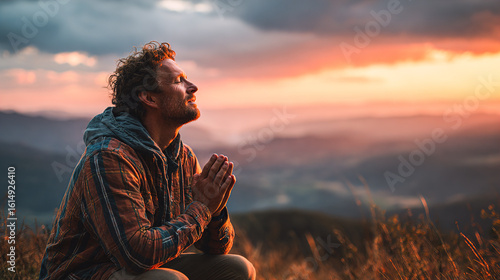 Man finds peace in nature, praying at sunset over mountains, seeking hope and gratitude with stunning scenic backdrop for wellness retreats