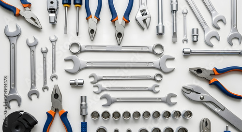 An organized flat lay of a comprehensive toolkit, featuring an assortment of wrenches, pliers, and sockets for professional repair and DIY projects.