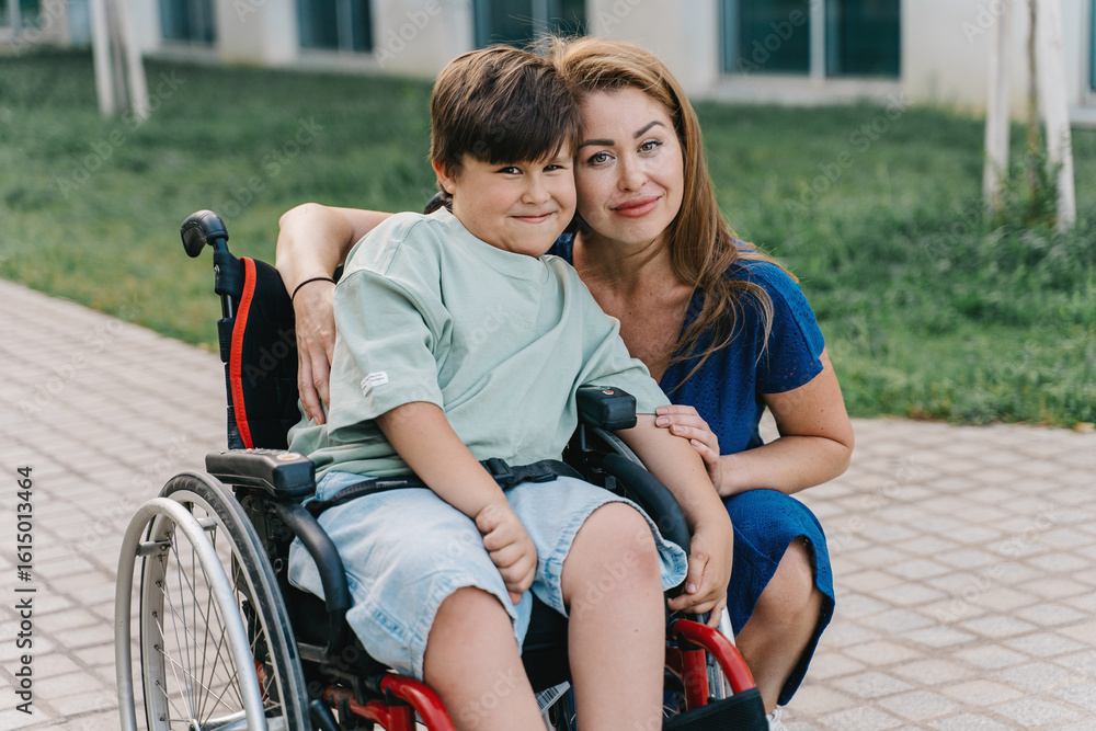 Obraz premium Portrait of a mother and son with sma desease in a wheelchair