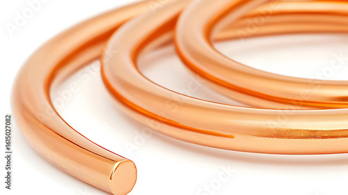 Copper coil, close-up view. Smooth, polished copper wire is coiled, showing a polished, reddish-orange hue.  A portion of the coil is cut and presented against white background
