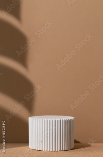 White podium with the shadow of a monstera leaf on a wooden beige background. Geometric premium scene for advertising and presentation your product. Showcase, display case