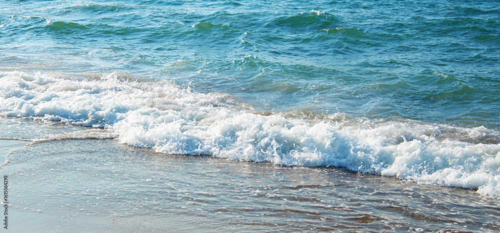 Fototapeta premium Soft wave of blue sea on sandy beach.
