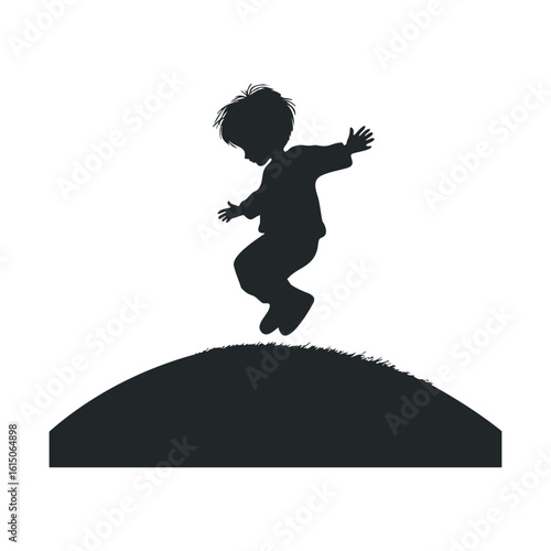 Silhouette of a caucasian male child jumping on a hill