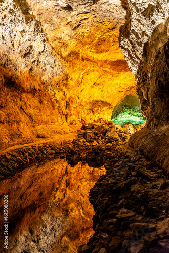 Cueva de los Verdes – Illuminated volcanic lava tube on the Canary Island of Lanzarote with a perfect reflection in a natural lagoon