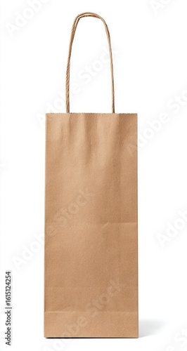 Tall tan bag with twisted paper handles stands on white. Simple, minimalist design. Shadow cast to right. Clean presentation. Isolated image