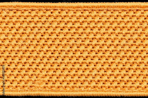 Close-up of a textured,  golden-orange fabric strip