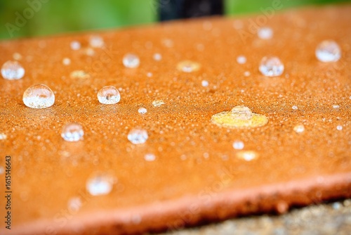 Water droplets on terracotta tile surface
