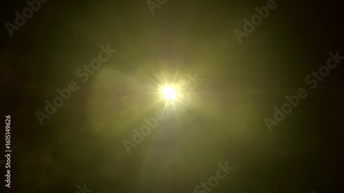 Colored rays emerge from the central white point and move on a black background. The projector operates in a smoky space