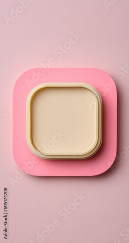 Minimalist composition of a rounded square pale cream tray atop a pink square, both against a soft pink background, creating a clean, simple, and visually appealing design