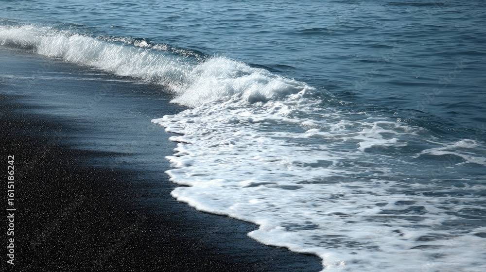 Fototapeta premium Foamy waves lapping at a dark beach.
