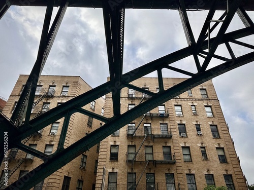 Diagonal Subway Support Framing Harlem Brick Buildings (New York, New York, USA)