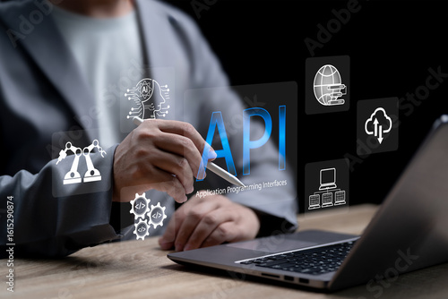 API-Application Programming Interface concept,Businessman use AI to Software development tool provides interface for communication between applications development with existing systems for efficiency