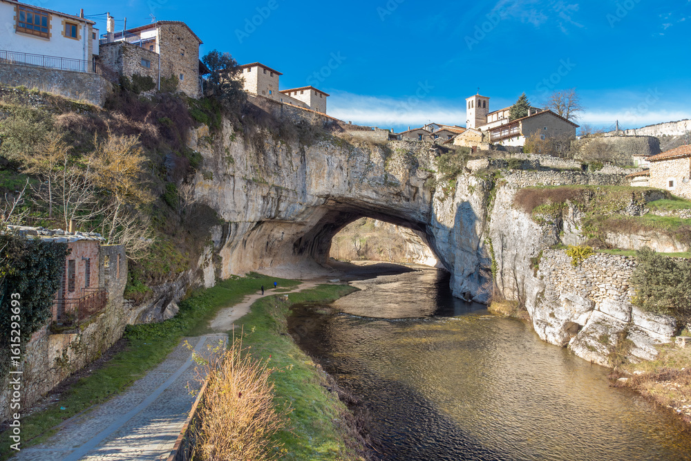 Obraz premium Aerial view of Puentedey, a picturesque village with a natural bridge over the river. Burgos, Spain. High quality photo