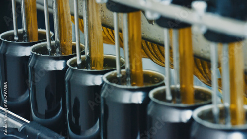 Automated machine pouring carbonated drink into aluminum cans on a production line in a modern beverage factory, representing industrial automation, efficiency, and mass production