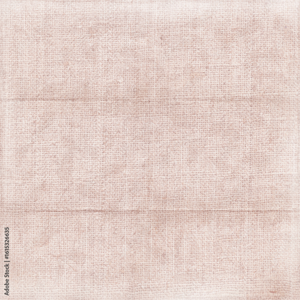 Fototapeta premium Soft dusty pink linen fabric texture with subtle folds and worn details, ideal for vintage-inspired design, feminine branding, stationery, and gentle textile backgrounds.