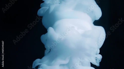 A stream of smoke descends onto a mirror surface, forming a beautiful cloud with circular diverging waves on a black background. Closeup. Macro. Slow mo, slow motion, high speed camera, 200fps