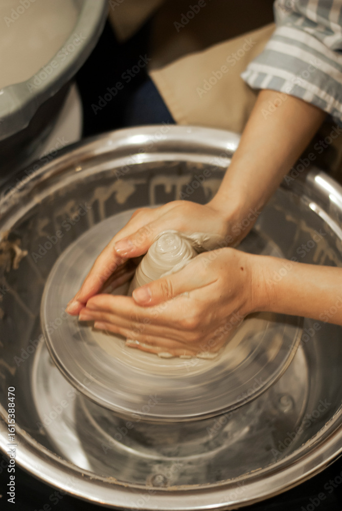 Fototapeta premium Hands crafting on pottery wheel 