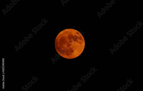 Surface of big red full moon on the dark sky background