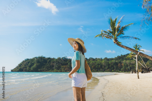 Happy traveler asian woman with hat relax on Klong chao beach at day in Koh Kood Trat Thailand Summer travel holiday vacation concept