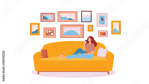Woman is relaxing on a yellow sofa while using her phone with pictures hanging on the wall behind her