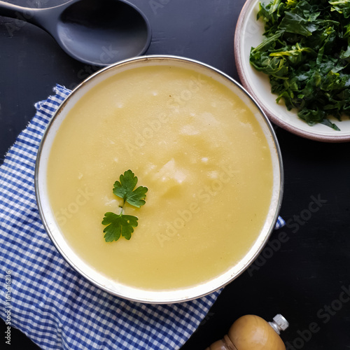 Angú, creamy corn polenta in a white bowl on a black background. Typical Brazilian food.
