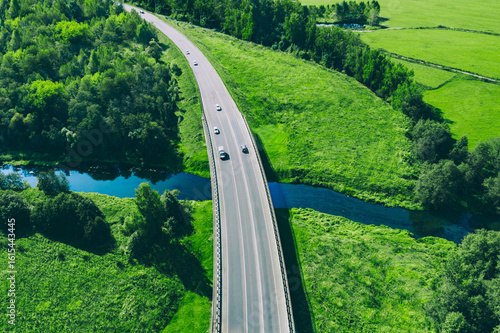 Canvastavla Aerial drone view of bridge asphalt road with hybrid and electric cars over blue