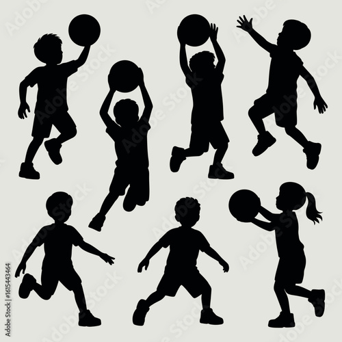 Silhouettes of children playing basketball with a ball