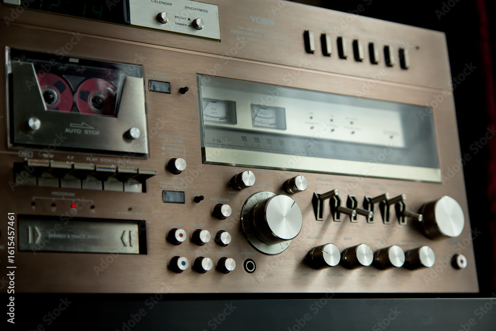 Obraz premium Vintage Audio Stereo Gear Setup Copper Front Panel with Multiple Controls Including Display, Knobs, Buttons, Keys, Switches