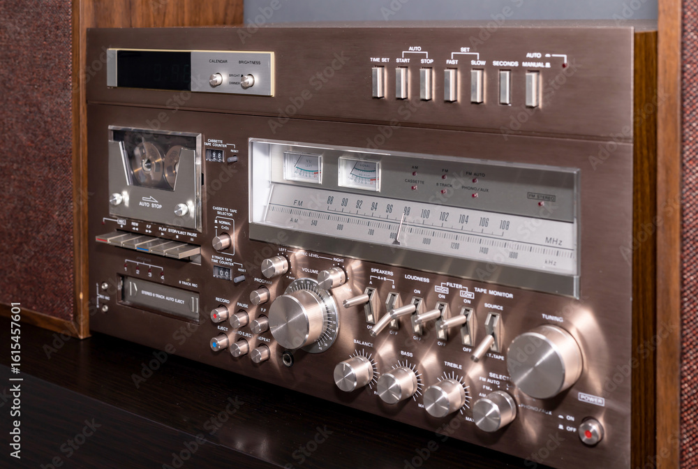 Fototapeta premium Vintage Audio Stereo Gear Setup Copper Front Panel with Multiple Controls Including Display, Knobs, Buttons, Keys, Switches
