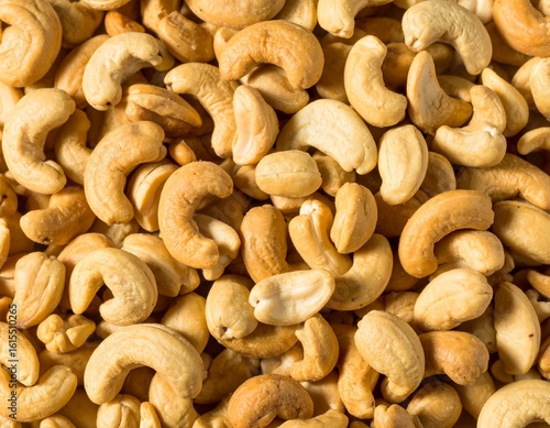 Close-up of cashews, showcasing their unique shape and inviting color ideal for themes of healthy snacks, vegan recipes, or wholesome ingredients. A collection of cashews, ready to be enjoyed 