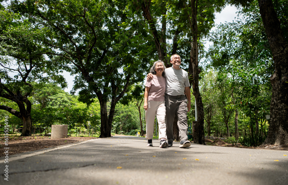 Happy Asian senior couple with exercise in a park, enjoying quality time outdoors Happy Asian senior couple with exercise in a park, enjoying quality time outdoors