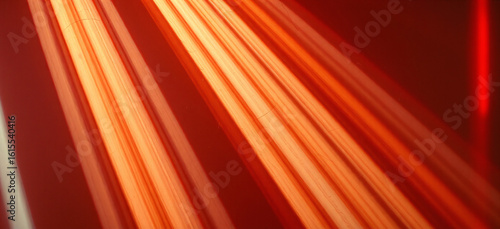 Bright red and orange light beams with scratches on a dark background, creating a vibrant contrast.