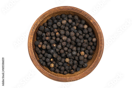 a wooden bowl filled with black pepper