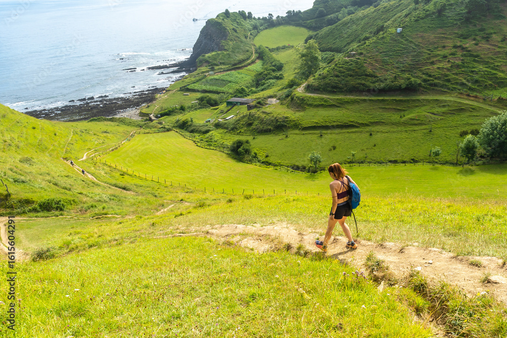 Obraz premium Hiker walking on sakoneta beach in zumaia, basque country, spain