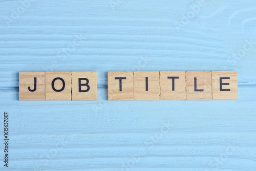 word job title made from wooden gray letters lies on a blue background
