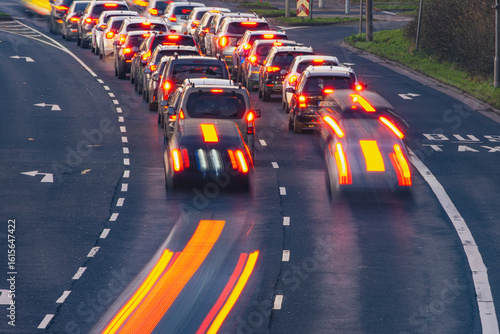 Blurry cars in motion on a busy road during the evening rush hour