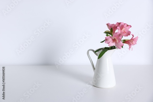 Wallpaper Mural Beautiful flowers in vase on white table, space for text Torontodigital.ca